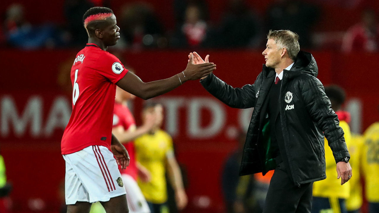 MANCHESTER, ENGLAND - SEPTEMBER 30: Paul Pogba of Manchester United and Ole Gunnar Solskjaer the head coach / manager of Manchester United during the Premier League match between Manchester United and Arsenal FC at Old Trafford on September 30, 2019 in Manchester, United Kingdom.