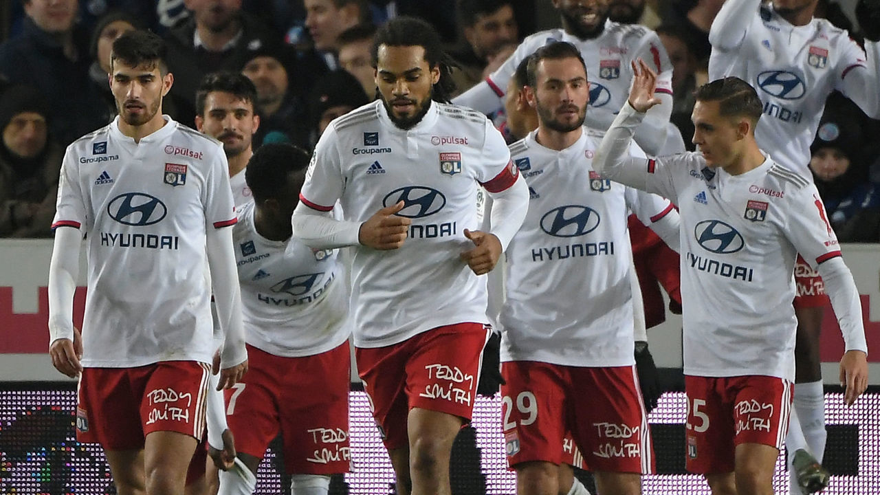 Lyon's players celebrate after scoring a goal during the French L1 football match between Strasbourg (RCSA) and Lyon (OL) at the Meinau stadium in Strasbourg, eastern France on November 30, 2019.