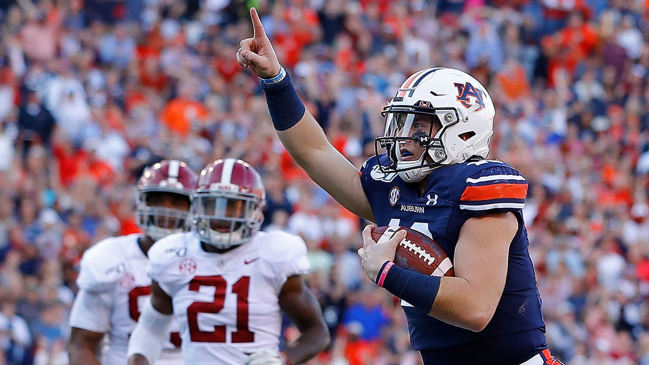 AUBURN, ALABAMA - NOVEMBER 30: Bo Nix #10 of the Auburn Tigers reacts as he rushes for a touchdown against the Alabama Crimson Tide in the first half at Jordan Hare Stadium on November 30, 2019 in Auburn, Alabama.