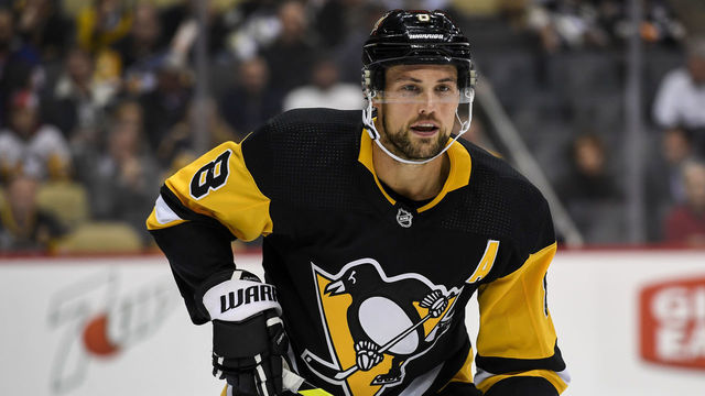 PITTSBURGH, PA - NOVEMBER 19: Pittsburgh Penguins Defenseman Brian Dumoulin (8) looks on during the first period in the NHL game between the Pittsburgh Penguins and the New York Islanders on November 19, 2019, at PPG Paints Arena in Pittsburgh, PA.