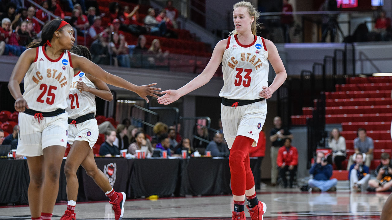 RALEIGH, NC - MARCH 23: NC State Wolfpack center Elissa Cunane (33) and NC State Wolfpack forward Kayla Jones (25) celebrate after the bucket during the 2019 Div 1 Women's Championship - First Round college basketball game between the Maine Black Bears and NC State Wolfpack on March 23, 2019, at Reynolds Coliseum in Raleigh, NC.