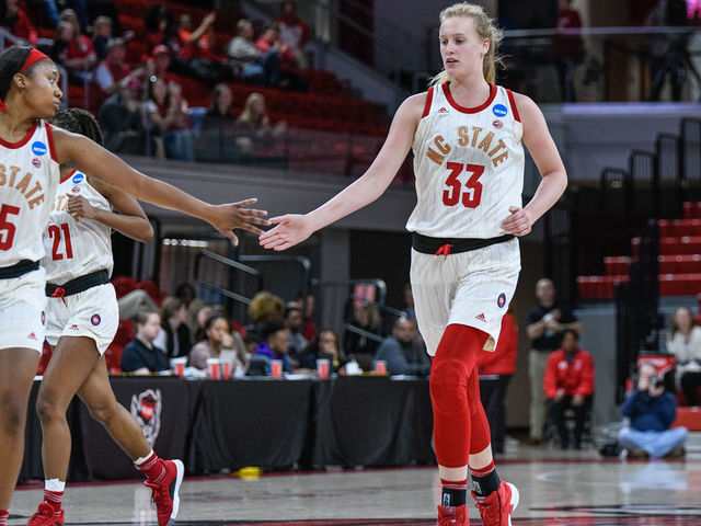 RALEIGH, NC - MARCH 23: NC State Wolfpack center Elissa Cunane (33) and NC State Wolfpack forward Kayla Jones (25) celebrate after the bucket during the 2019 Div 1 Women's Championship - First Round college basketball game between the Maine Black Bears and NC State Wolfpack on March 23, 2019, at Reynolds Coliseum in Raleigh, NC.
