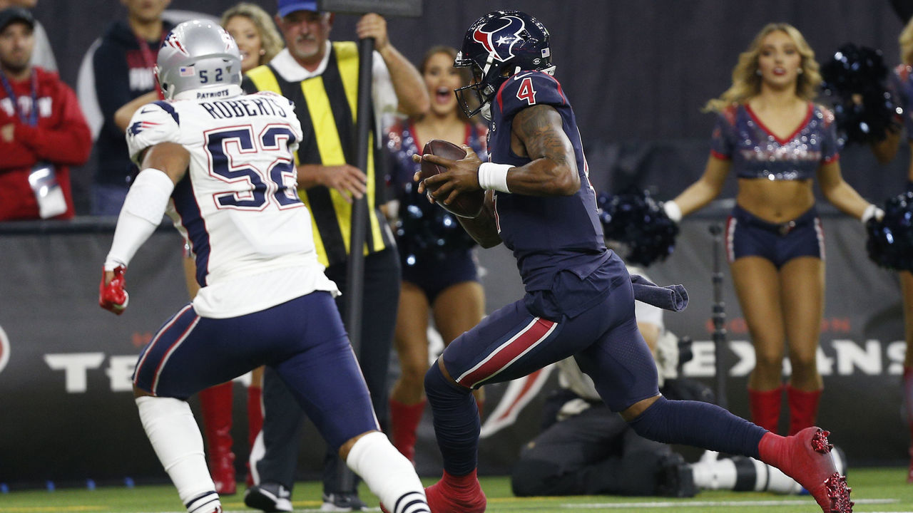 HOUSTON, TEXAS - DECEMBER 01: Deshaun Watson #4 of the Houston Texans runs six yards for a touchdown during the fourth quarter as he beats Elandon Roberts #52 of the New England Patriots and Devin McCourty #32 to the pylon at NRG Stadium on December 01, 2019 in Houston, Texas.