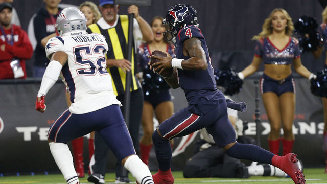 HOUSTON, TEXAS - DECEMBER 01: Deshaun Watson #4 of the Houston Texans runs six yards for a touchdown during the fourth quarter as he beats Elandon Roberts #52 of the New England Patriots and Devin McCourty #32 to the pylon at NRG Stadium on December 01, 2019 in Houston, Texas.