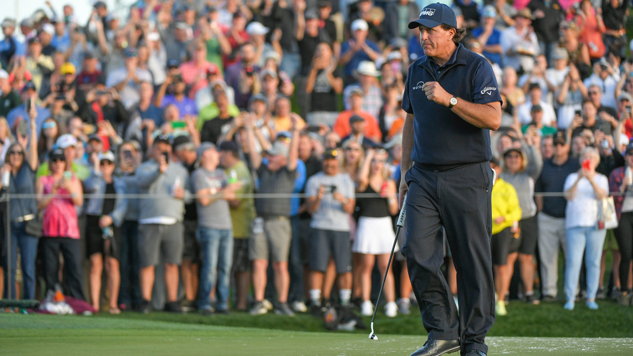 SCOTTSDALE, AZ - JANUARY 31: Phil Mickelson makes a putt on the eighteenth hole green during the first round of the Waste Management Phoenix Open at TPC Scottsdale on January 31, 2019 in Scottsdale, Arizona.