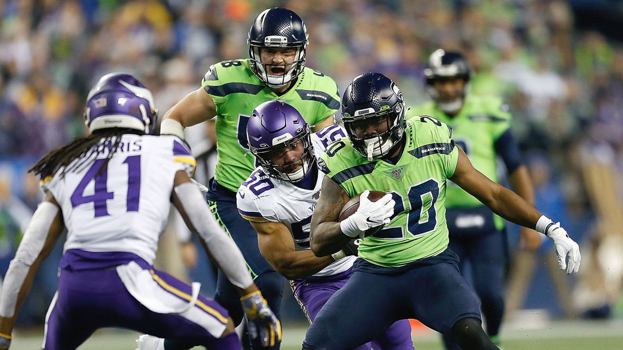 SEATTLE, WASHINGTON - DECEMBER 02: Running back Rashaad Penny #20 of the Seattle Seahawks carries the ball against the defense of the Minnesota Vikings at CenturyLink Field on December 02, 2019 in Seattle, Washington.