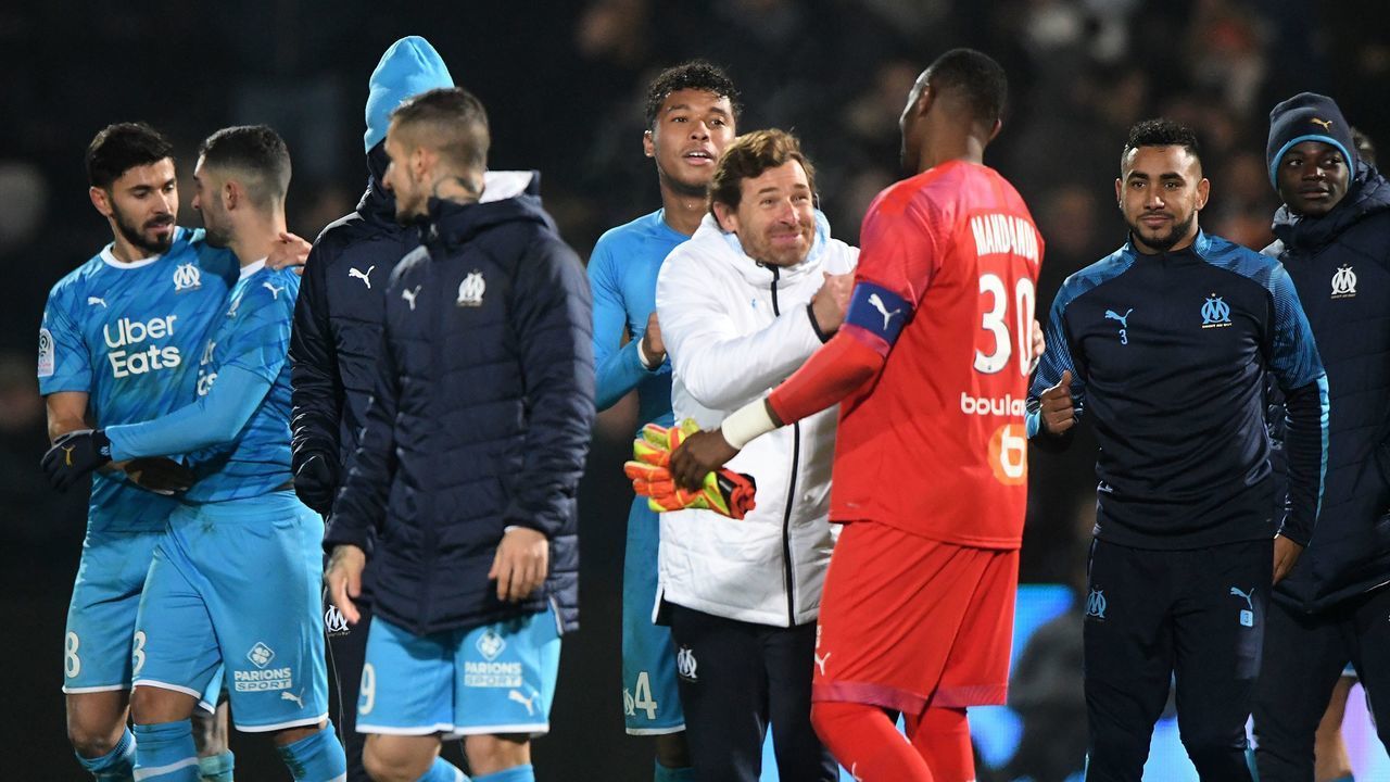 Marseille's Portuguese coach Andre Villas Boas (4-R) celebrate with Marseille's French goalkeeper Steve Mandanda at the end of the French L1 Football match between Angers SCO and Olympique de Marseille, at Raymond-Kopa Stadium, in Angers, northwestern France, on December 3, 2019.