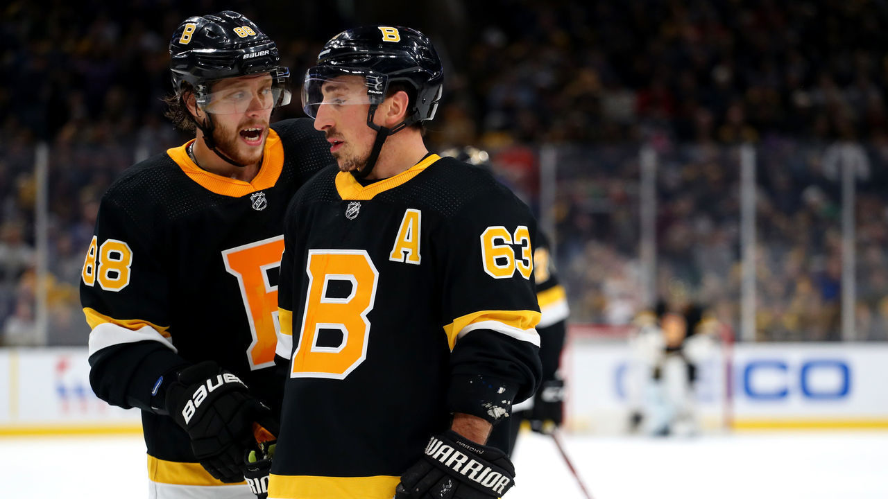 BOSTON, MASSACHUSETTS - NOVEMBER 29: David Pastrnak #88 of the Boston Bruins and Brad Marchand #63 talk during the third period against the New York Rangers at TD Garden on November 29, 2019 in Boston, Massachusetts.