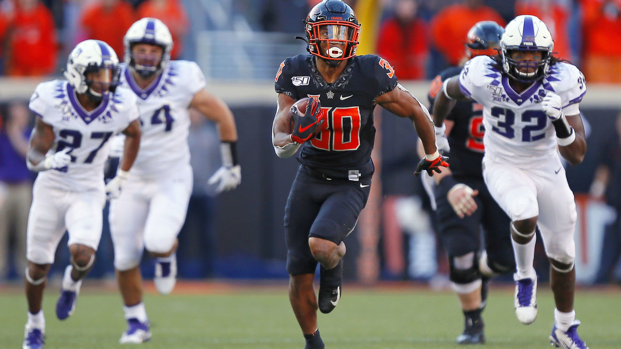 STILLWATER, OK - NOVEMBER 2: Running back Chuba Hubbard #30 of the Oklahoma State Cowboys breaks loose on a 62-yard run to score a touchdown against safety Ar'Darius Washington #27 and defensive end Ochaun Mathis #32 of the TCU Horned Frogs on November 2, 2019 at Boone Pickens Stadium in Stillwater, Oklahoma. OSU won 34-27.