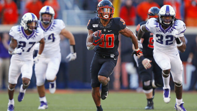 STILLWATER, OK - NOVEMBER 2: Running back Chuba Hubbard #30 of the Oklahoma State Cowboys breaks loose on a 62-yard run to score a touchdown against safety Ar'Darius Washington #27 and defensive end Ochaun Mathis #32 of the TCU Horned Frogs on November 2, 2019 at Boone Pickens Stadium in Stillwater, Oklahoma. OSU won 34-27.