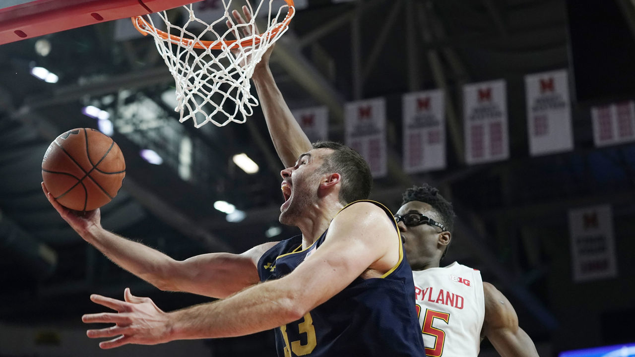 COLLEGE PARK, MD - DECEMBER 04: John Mooney #33 of the Notre Dame Fighting Irish attempts a layup against Jalen Smith #25 of the Maryland Terrapins in the first half at Xfinity Center on December 4, 2019 in College Park, Maryland.