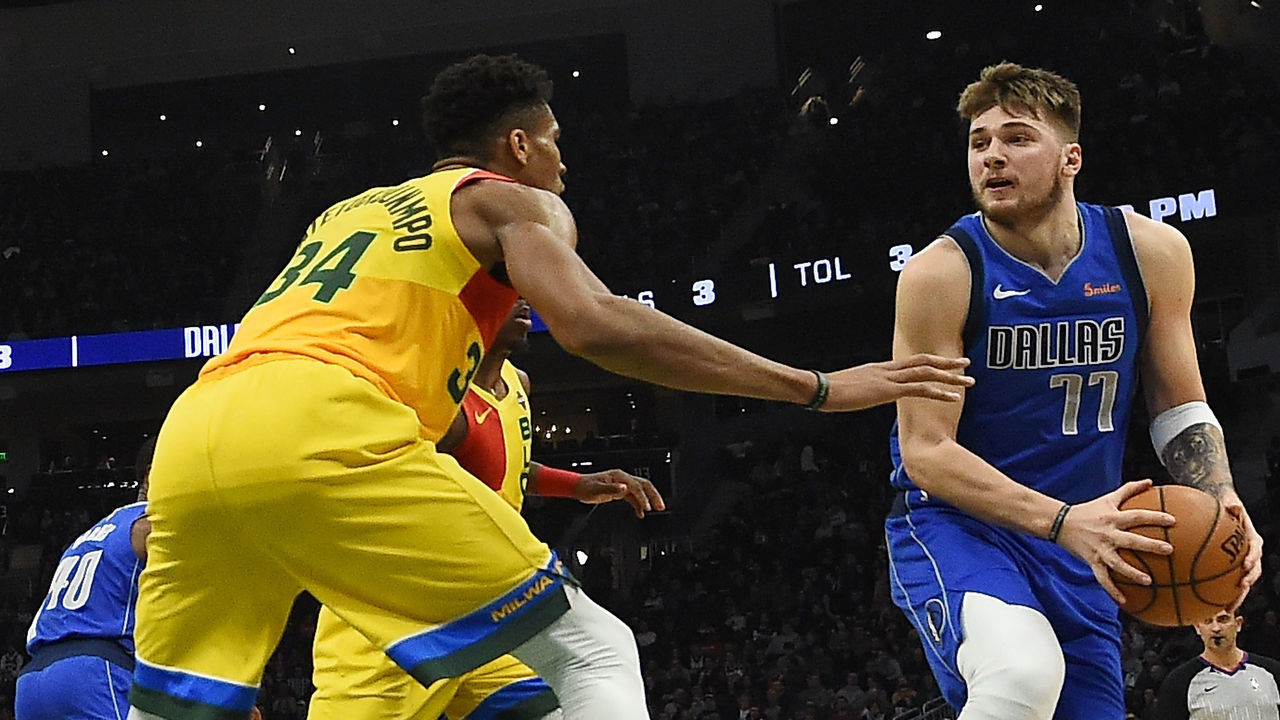 MILWAUKEE, WISCONSIN - JANUARY 21: Luka Doncic #77 of the Dallas Mavericks works against Giannis Antetokounmpo #34 of the Milwaukee Bucks during a game at Fiserv Forum on January 21, 2019 in Milwaukee, Wisconsin.