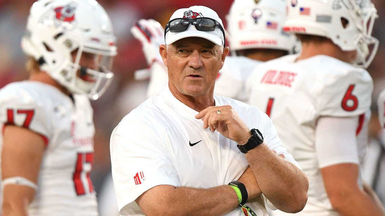 LOS ANGELES, CALIFORNIA - AUGUST 31: Head coach Jeff Tedford of the Fresno State Bulldogs watches warm up before the game against the USC Trojans at Los Angeles Memorial Coliseum on August 31, 2019 in Los Angeles, California.