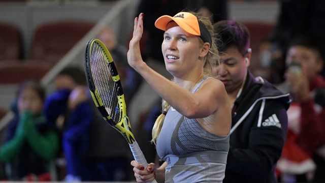 Caroline Wozniacki of Denmark waves after her women's singles quarter-final match against Daria Kasatkina of Russia at the China Open tennis tournament in Beijing on October 4, 2019.