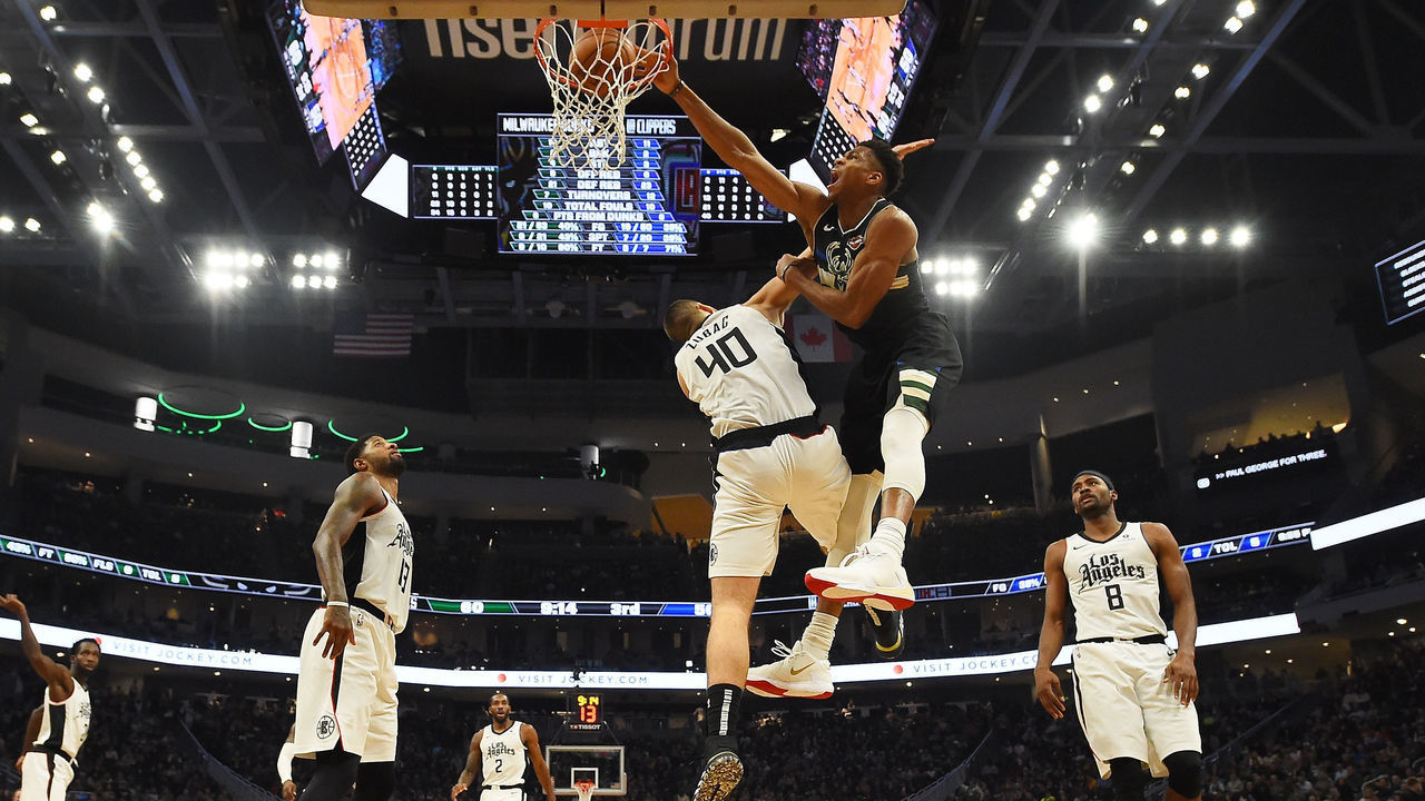 MILWAUKEE, WISCONSIN - DECEMBER 06: Giannis Antetokounmpo #34 of the Milwaukee Bucks dunks over Ivica Zubac #40 of the Los Angeles Clippers during the second half of a game at Fiserv Forum on December 06, 2019 in Milwaukee, Wisconsin.