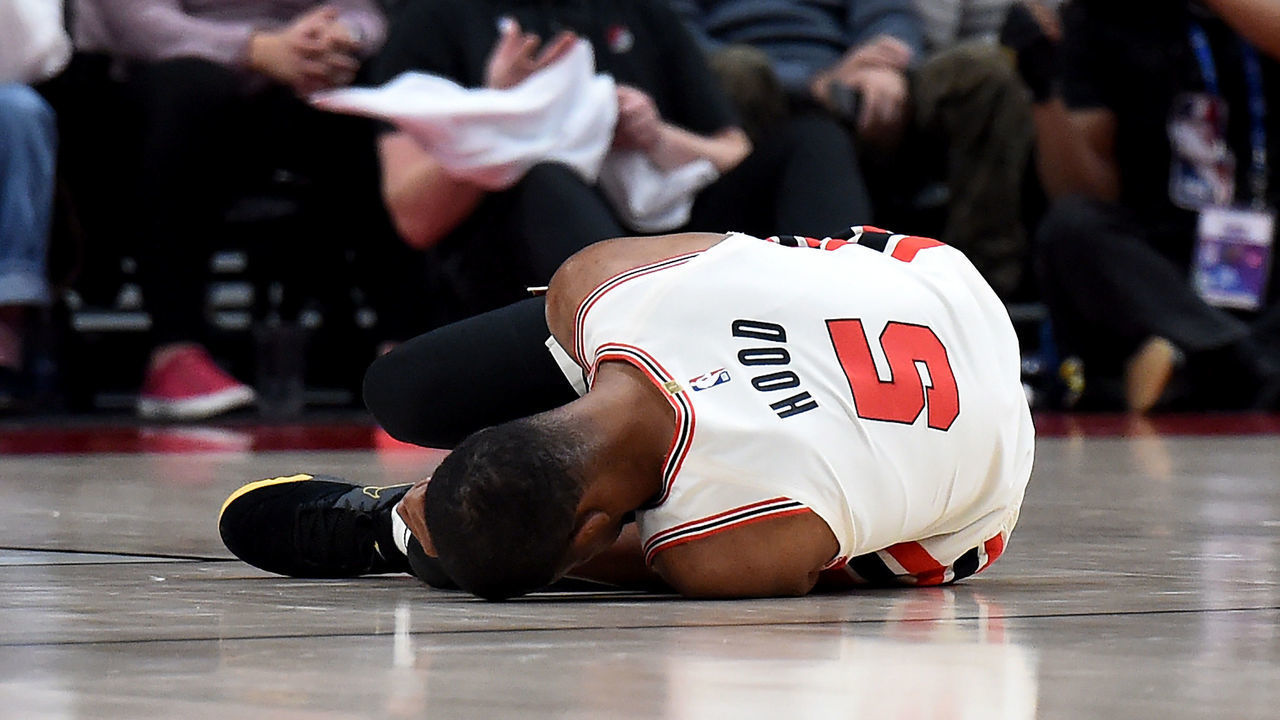 PORTLAND, OREGON - DECEMBER 06: Rodney Hood #5 of the Portland Trail Blazers lays on the court after being injured during the first half of the game against the Los Angeles Lakers at Moda Center on December 06, 2019 in Portland, Oregon.