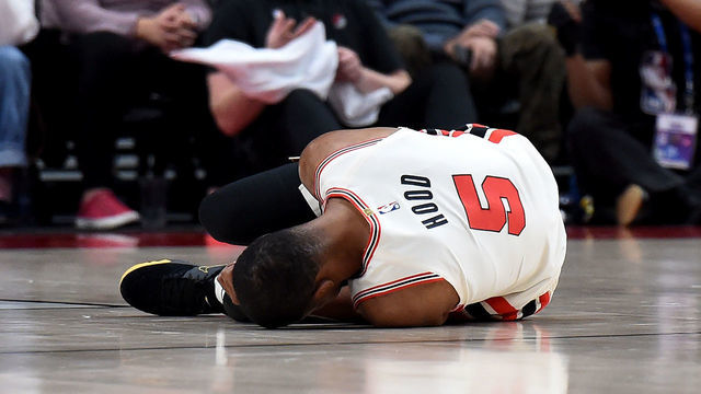 PORTLAND, OREGON - DECEMBER 06: Rodney Hood #5 of the Portland Trail Blazers lays on the court after being injured during the first half of the game against the Los Angeles Lakers at Moda Center on December 06, 2019 in Portland, Oregon.