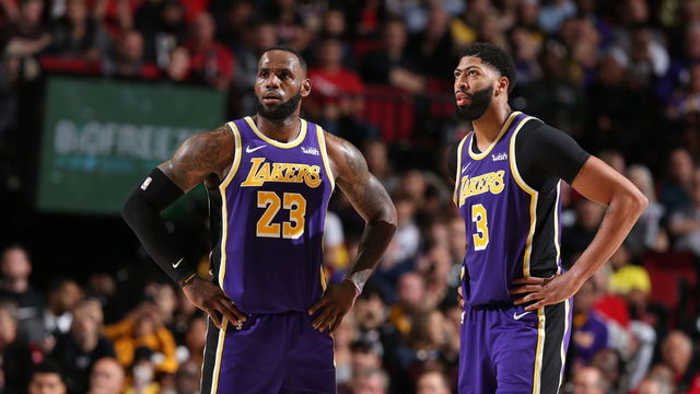 PORTLAND, OR - DECEMBER 6: LeBron James #23 of the Los Angeles Lakers and Anthony Davis #3 of the Los Angeles Lakers look on during a game against the Portland Trail Blazers on December 6, 2019 at the Moda Center Arena in Portland, Oregon. Mandatory Copyright Notice: Copyright 2019 NBAE