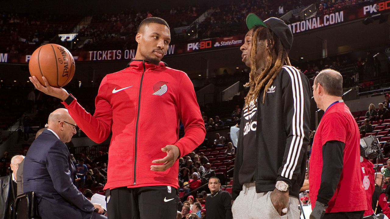 PORTLAND, OR - NOVEMBER 5: Damian Lillard #0 of the Portland Trail Blazers talks with Rapper, Lil Wayne before the game against the Oklahoma City Thunder on November 5, 2017 at the Moda Center Arena in Portland, Oregon. Mandatory Copyright Notice: Copyright 2017 NBAE