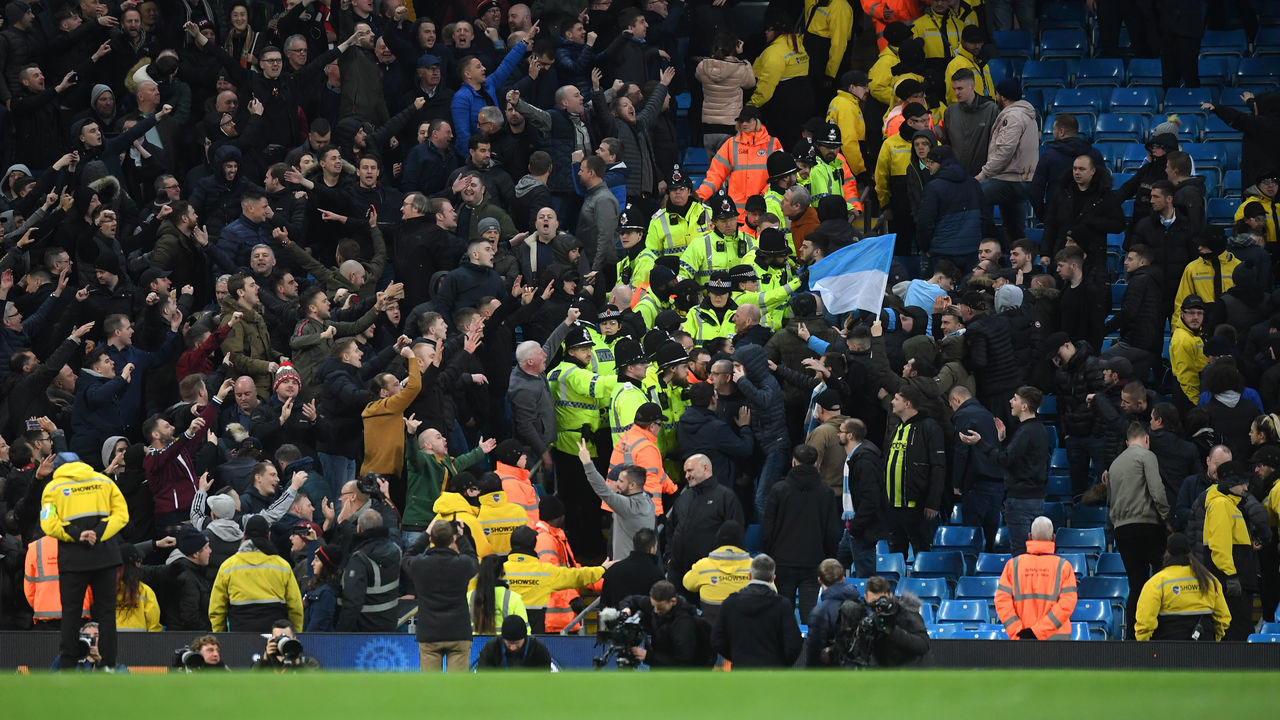 MANCHESTER, ENGLAND - DECEMBER 07: Manchester United fans clash with Manchester City fans following the Premier League match between Manchester City and Manchester United at Etihad Stadium on December 07, 2019 in Manchester, United Kingdom.