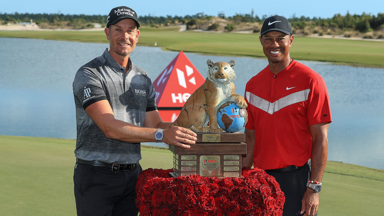 NASSAU, BAHAMAS - DECEMBER 07: Tiger Woods of the United States the tournament host presents Henrik Stenson of Sweden with the trophy after the final round of the 2019 Hero World Challenge at Albany on December 07, 2019 in Nassau, Bahamas.