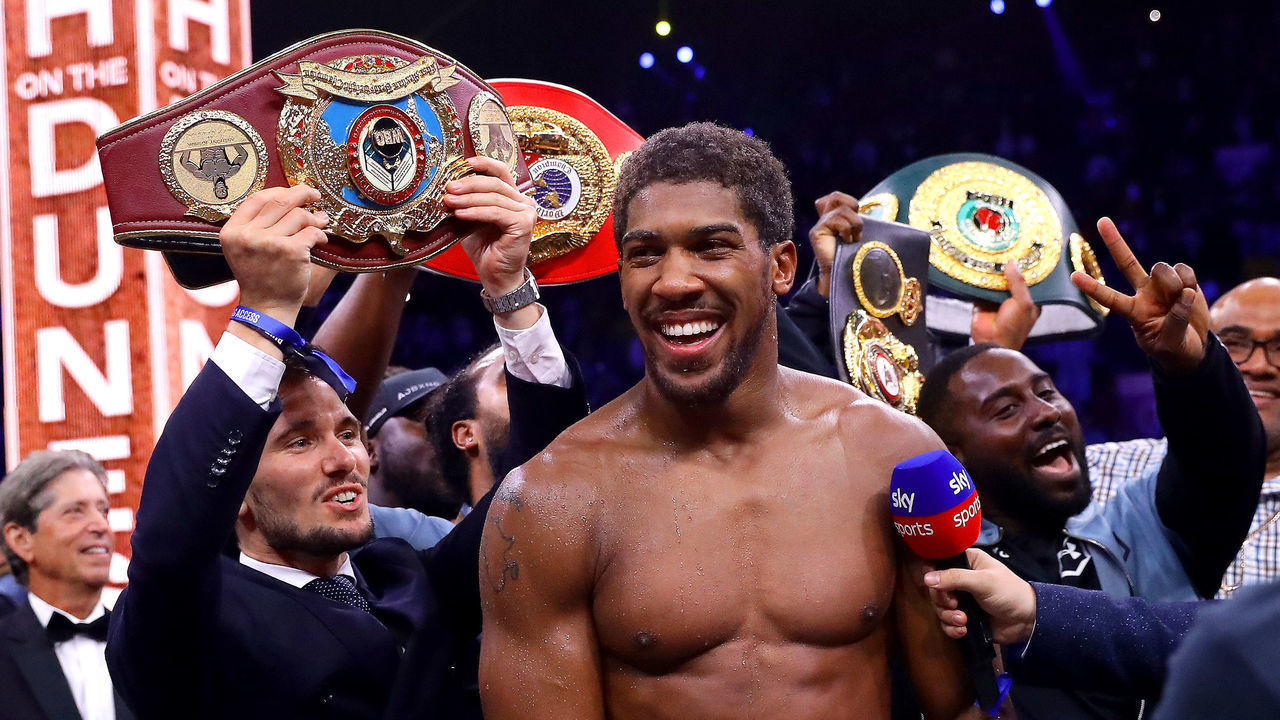 DIRIYAH, SAUDI ARABIA - DECEMBER 07: Anthony Joshua celebrates victory over Andy Ruiz Jr during the IBF, WBA, WBO & IBO World Heavyweight Title Fight between Andy Ruiz Jr and Anthony Joshua during the Matchroom Boxing 'Clash on the Dunes' show at the Diriyah Season on December 07, 2019 in Diriyah, Saudi Arabia