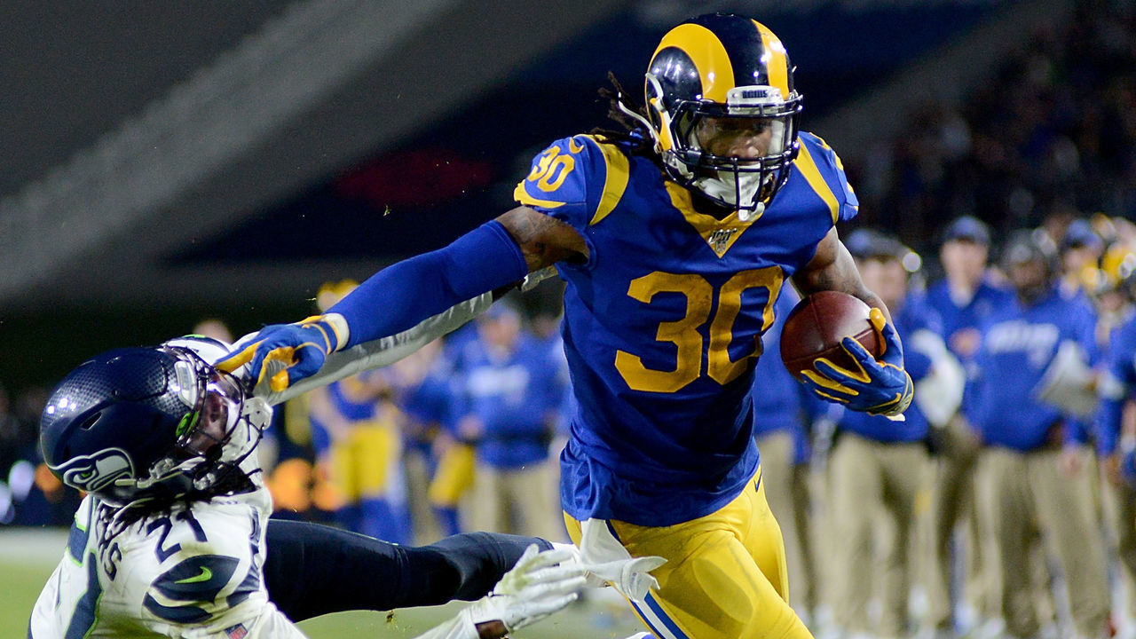 LOS ANGELES, CALIFORNIA - DECEMBER 08: Running back Todd Gurley #30 of the Los Angeles Rams stiff arms cornerback Tre Flowers #21 of the Seattle Seahawks on his way to a touchdown in the fourth quarter of the game at Los Angeles Memorial Coliseum on December 08, 2019 in Los Angeles, California.