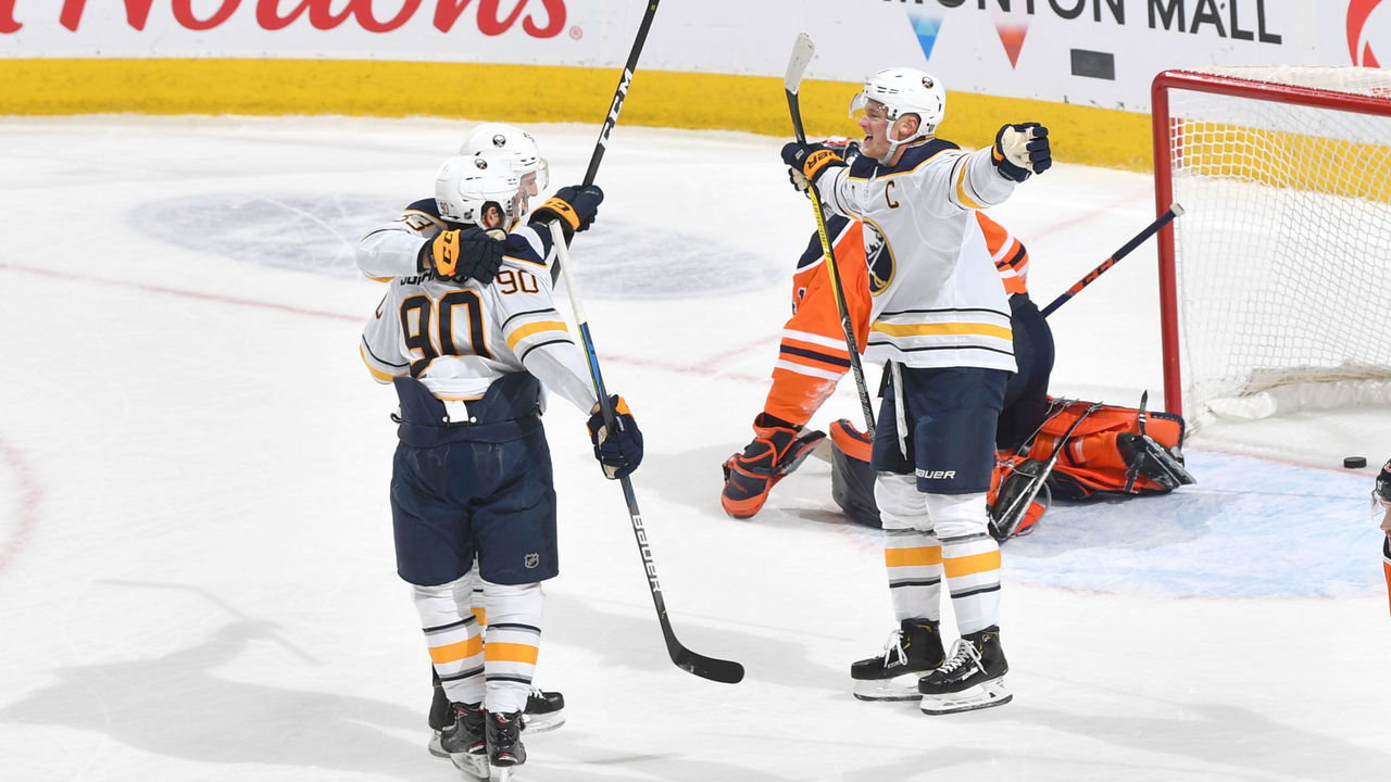 EDMONTON, AB - DECEMBER 8: Colin Miller #33, Marcus Johansson #90 and Jack Eichel #9 of the Buffalo Sabres celebrate after winning the game against the Edmonton Oilers on December 8, 2019, at Rogers Place in Edmonton, Alberta, Canada.