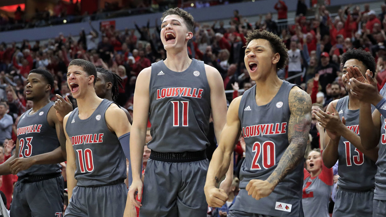 LOUISVILLE, KENTUCKY - DECEMBER 06: Samuell Wiliiamson #10, Quinn Slazinski #11 and Josh Nickelberry #20 of the Louisville Cardinals celebrate during the game against the Pittsburgh Panthers at KFC YUM! Center on December 06, 2019 in Louisville, Kentucky.
