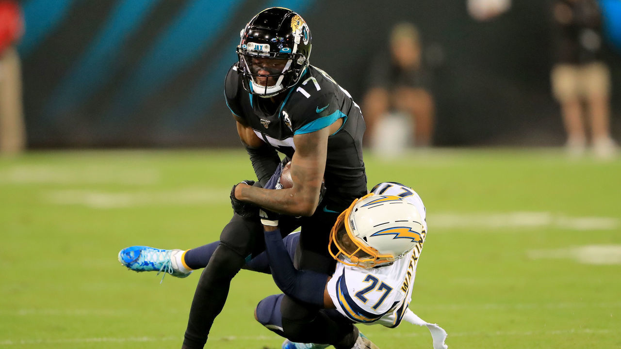 JACKSONVILLE, FLORIDA - DECEMBER 08: Jaylen Watkins #27 of the Los Angeles Chargers attempts to tackle D.J. Chark #17 of the Jacksonville Jaguars during the game at TIAA Bank Field on December 08, 2019 in Jacksonville, Florida.