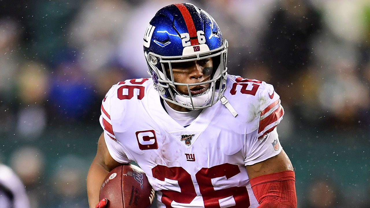 PHILADELPHIA, PENNSYLVANIA - DECEMBER 09: Running back Saquon Barkley #26 of the New York Giants carries the ball against the defense of the Philadelphia Eagles during the game at Lincoln Financial Field on December 09, 2019 in Philadelphia, Pennsylvania.