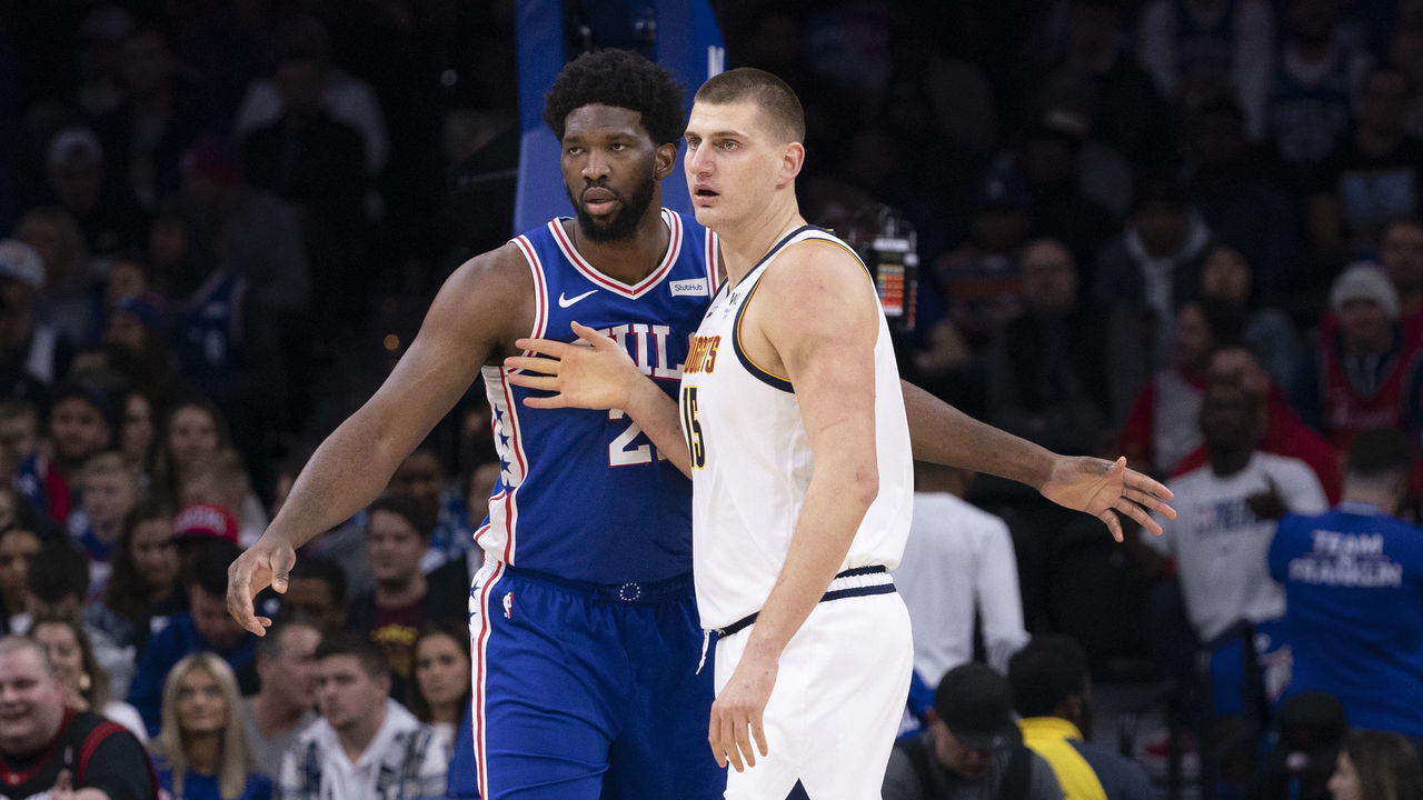 PHILADELPHIA, PA - DECEMBER 10: Joel Embiid #21 of the Philadelphia 76ers guards Nikola Jokic #15 of the Denver Nuggets in the first quarter at the Wells Fargo Center on December 10, 2019 in Philadelphia, Pennsylvania. NOTE TO USER: User expressly acknowledges and agrees that, by downloading and/or using this photograph, user is consenting to the terms and conditions of the Getty Images License Agreement.