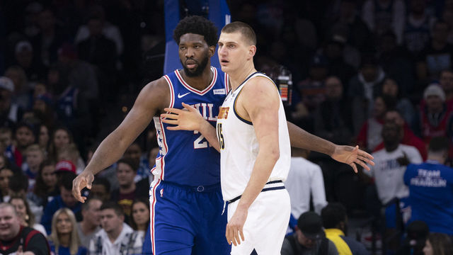 PHILADELPHIA, PA - DECEMBER 10: Joel Embiid #21 of the Philadelphia 76ers guards Nikola Jokic #15 of the Denver Nuggets in the first quarter at the Wells Fargo Center on December 10, 2019 in Philadelphia, Pennsylvania. NOTE TO USER: User expressly acknowledges and agrees that, by downloading and/or using this photograph, user is consenting to the terms and conditions of the Getty Images License Agreement.