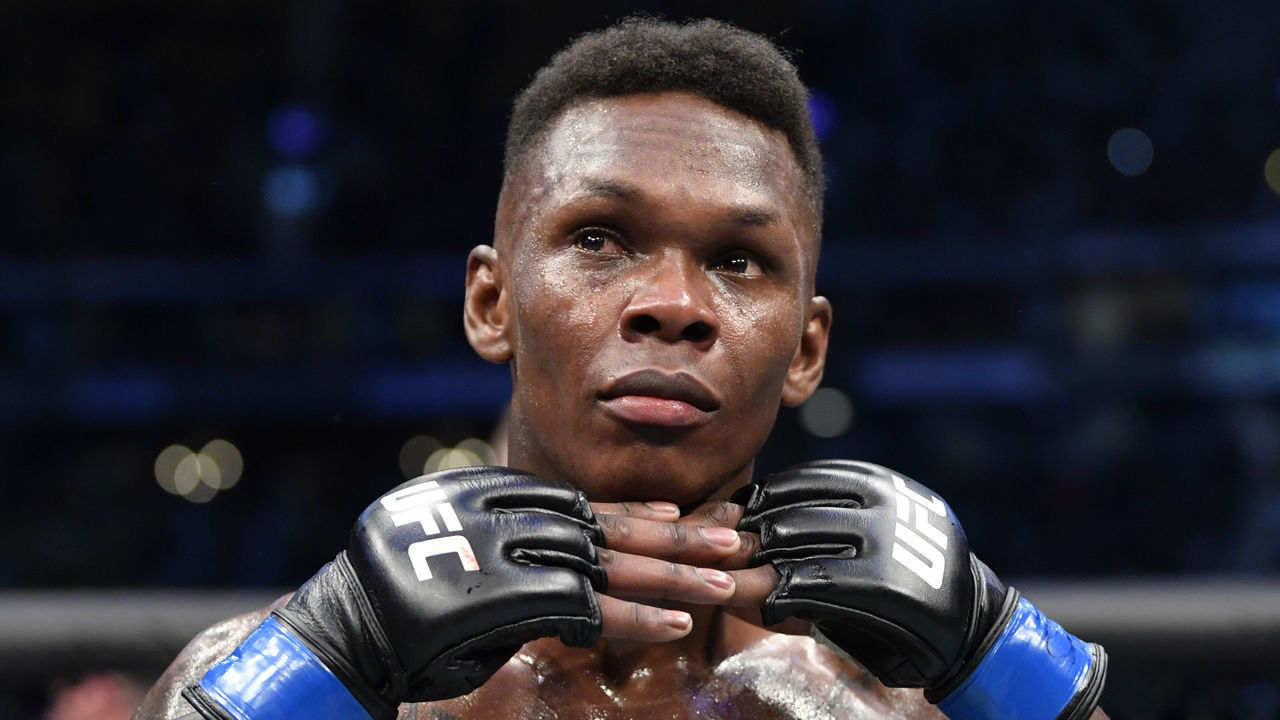 MELBOURNE, AUSTRALIA - OCTOBER 06: Israel Adesanya of Nigeria celebrates after his knockout victory over Robert Whittaker of New Zealand in their UFC middleweight championship fight during the UFC 243 event at Marvel Stadium on October 06, 2019 in Melbourne, Australia.
