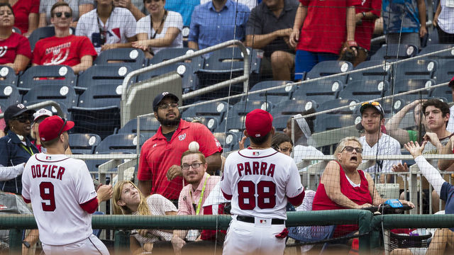 WASHINGTON, DC - JULY 31: A foul ball bounces off the new protective netting that was extended down the baselines in front of Gerardo Parra #88 and Brian Dozier #9 of the Washington Nationals during the fourth inning at Nationals Park on July 31, 2019 in Washington, DC.