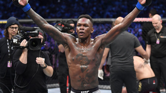MELBOURNE, AUSTRALIA - OCTOBER 06: Israel Adesanya of Nigeria celebrates after his knockout victory over Robert Whittaker of New Zealand in their UFC middleweight championship fight during the UFC 243 event at Marvel Stadium on October 06, 2019 in Melbourne, Australia.