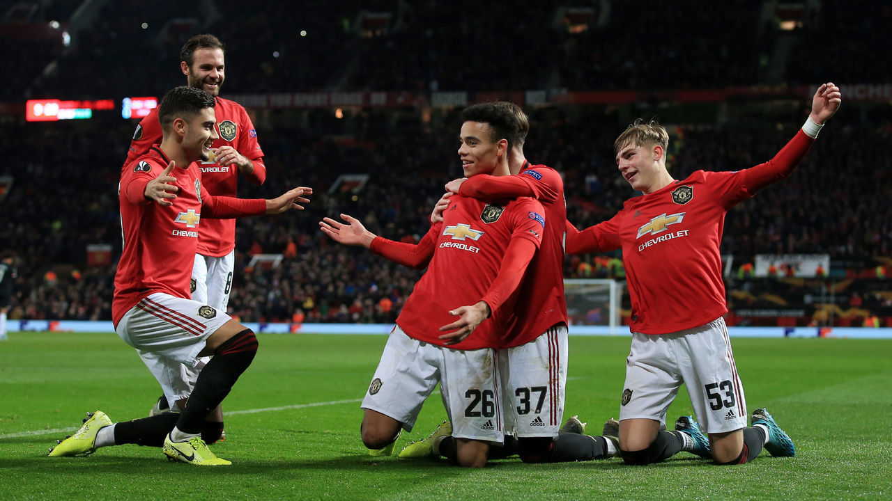 MANCHESTER, ENGLAND - DECEMBER 12: Mason Greenwood of Man Utd (C) is joined by Andreas Pereira of Man Utd (L) and James Garner of Man Utd (R) as he celebrates after scoring their 4th goal during the UEFA Europa League group L match between Manchester United and AZ Alkmaar at Old Trafford on December 12, 2019 in Manchester, United Kingdom.