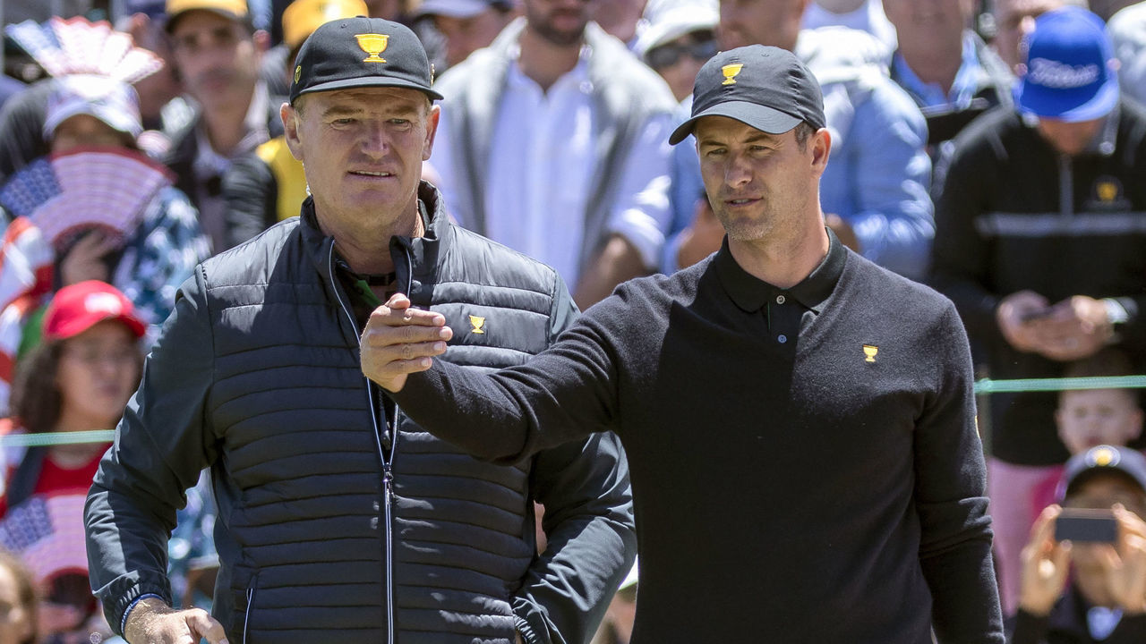 International Team player Adam Scott of Australia (R) discusses a putt with International Team captain Ernie Els of South Africa (L) on the 14th green during day one of the Presidents Cup golf tournament in Melbourne on December 12, 2019.