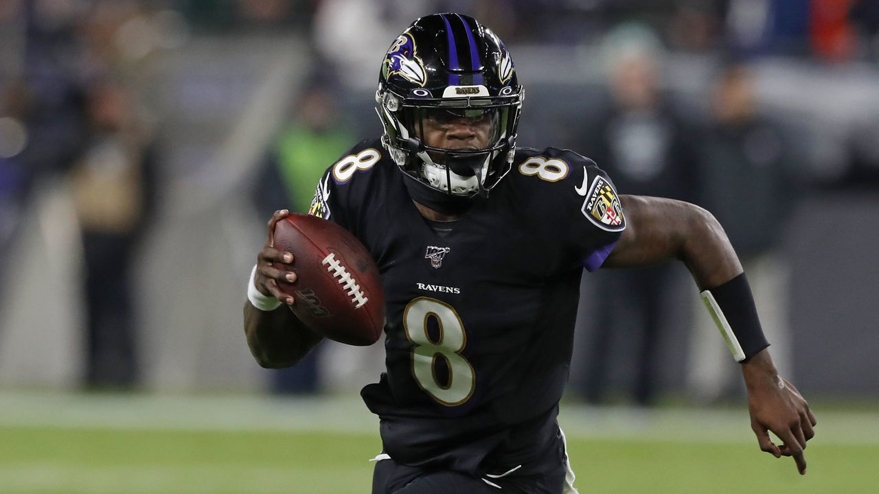 BALTIMORE, MARYLAND - DECEMBER 12: Quarterback Lamar Jackson #8 of the Baltimore Ravens breaks NFL single season record for rushing yards by a quarterback, formerly held by Michael Vick in the first quarter of the game at M&T Bank Stadium on December 12, 2019 in Baltimore, Maryland.