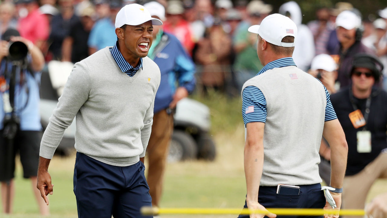 MELBOURNE, AUSTRALIA - DECEMBER 13: Playing Captain Tiger Woods of the United States team and Justin Thomas of the United States team celebrate defeating Byeong-Hun An of South Korea and the International team and Hideki Matsuyama of Japan and the International team 1up on the 18th green during Friday foursome matches on day two of the 2019 Presidents Cup at Royal Melbourne Golf Course on December 13, 2019 in Melbourne, Australia.