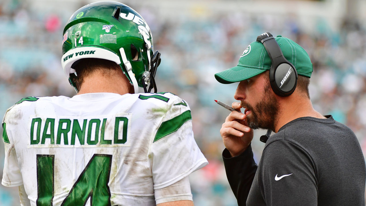 JACKSONVILLE, FLORIDA - OCTOBER 27: Sam Darnold #14 and head coach Adam Gase of the New York Jets meet on the field during a timeout in the fourth quarter of a football game against the Jacksonville Jaguars at TIAA Bank Field on October 27, 2019 in Jacksonville, Florida.