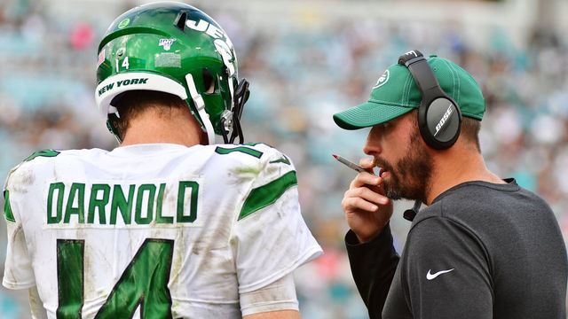 JACKSONVILLE, FLORIDA - OCTOBER 27: Sam Darnold #14 and head coach Adam Gase of the New York Jets meet on the field during a timeout in the fourth quarter of a football game against the Jacksonville Jaguars at TIAA Bank Field on October 27, 2019 in Jacksonville, Florida.