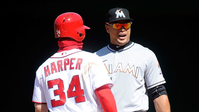 WASHINGTON, DC - APRIL 10: Bryce Harper #34 of the Washington Nationals talks with Giancarlo Stanton #27 of the Miami Marlins during a play review in the fifth inning at Nationals Park on April 10, 2016 in Washington, DC.