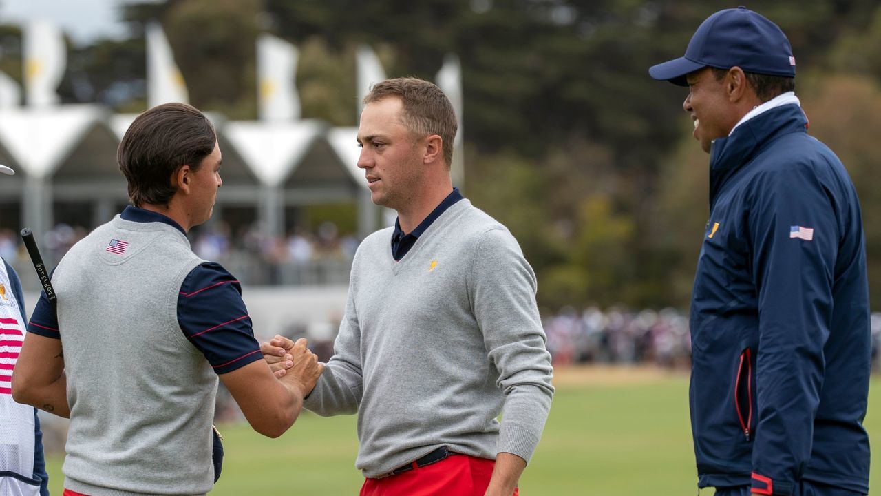 USA team member Rickie Fowler (Left) and Justin Thomas celebrate winning their match as team captain Tiger Woods (Right) looks on during the Presidents Cup golf tournament in Melbourne on December 14, 2019.