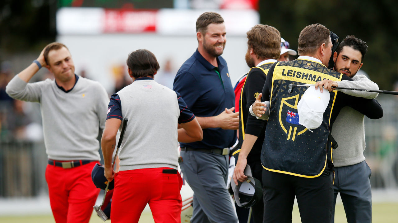 MELBOURNE, AUSTRALIA - DECEMBER 14: Marc Leishman of Australia and the International team and Abraham Ancer of Mexico and the International team celebrate after halving their match against Justin Thomas of the United States team and Rickie Fowler of the United States team during Saturday afternoon foursomes matches on day three of the 2019 Presidents Cup at Royal Melbourne Golf Course on December 14, 2019 in Melbourne, Australia.
