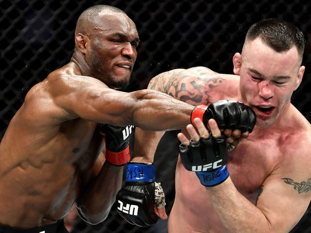 LAS VEGAS, NEVADA - DECEMBER 14: (L-R) Kamaru Usman of Nigeria strikes Colby Covington in their UFC welterweight championship bout during the UFC 245 event at T-Mobile Arena on December 14, 2019 in Las Vegas, Nevada.