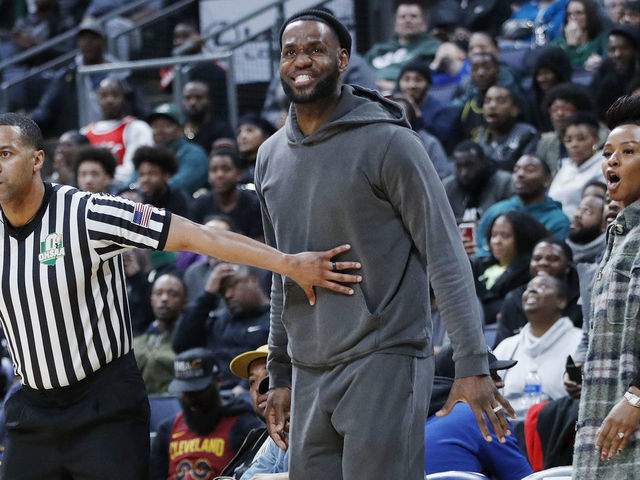 COLUMBUS, OH - DECEMBER 14: LeBron James of the Los Angeles Lakers is restrained by a referee while watching son Bronny play with Sierra Canyon High School during the Ohio Scholastic Play-By-Play Classic against St. Vincent-St. Mary High School at Nationwide Arena on December 14, 2019 in Columbus, Ohio.
