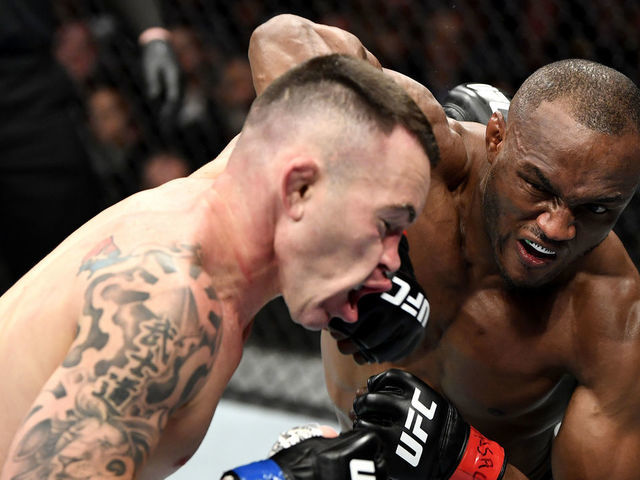 LAS VEGAS, NEVADA - DECEMBER 14: (R-L) Kamaru Usman of Nigeria strikes Colby Covington in their UFC welterweight championship bout during the UFC 245 event at T-Mobile Arena on December 14, 2019 in Las Vegas, Nevada.