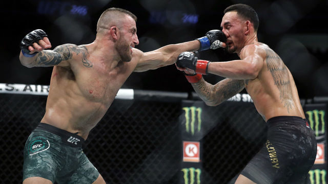 LAS VEGAS, NEVADA - DECEMBER 14: Alexander Volkanovski (L) punches UFC featherweight champion Max Holloway in their title fight during UFC 245 at T-Mobile Arena on December 14, 2019 in Las Vegas, Nevada. Volkanovski took the title by unanimous decision.