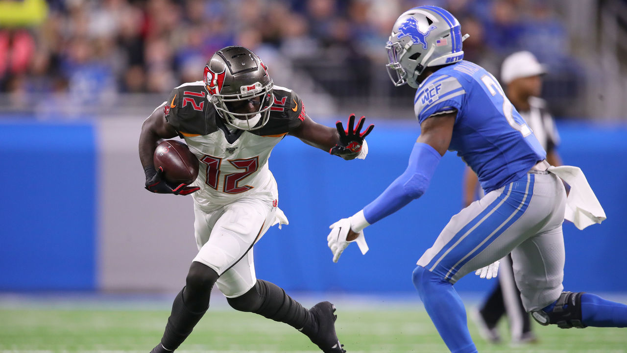 DETROIT, MICHIGAN - DECEMBER 15: Chris Godwin #12 of the Tampa Bay Buccaneers battles for yards against Tracy Walker #21 of the Detroit Lions during the first half at Ford Field on December 15, 2019 in Detroit, Michigan.
